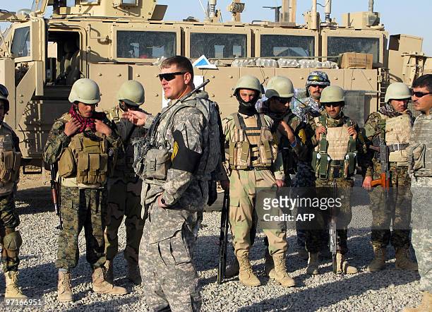 Army sergeant gives a briefing to US troops, Iraqi policemen, soldiers and Kurdish peshmerga fighters prior to conducting a combined security force...