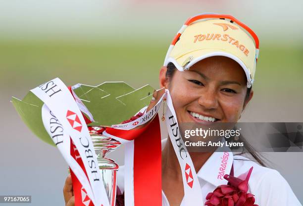 Ai Miyazato of Japan holds the winner's trophy after winning the HSBC Women's Champions at Tanah Merah Country Club on February 28, 2010 in...