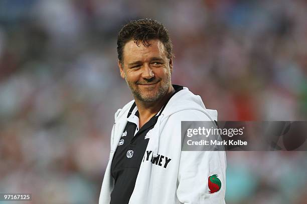 Russell Crowe smiles to the crowd during the Rabbitohs warm-up before the NRL Charity Shield match between the South Sydney Rabbitohs and the St...