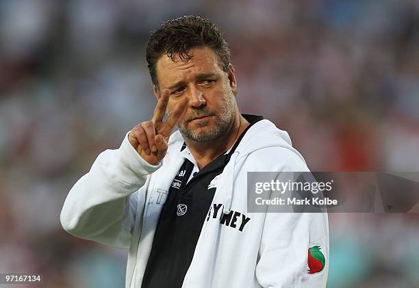 Russell Crowe waves to the crowd during the Rabbitohs warm-up before the NRL Charity Shield match between the South Sydney Rabbitohs and the St...