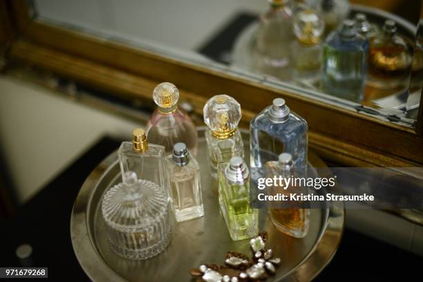 perfume bottles on a tray by a mirror - perfume sprayer stock pictures, royalty-free photos & images