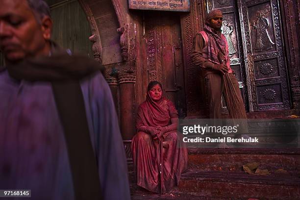 Hindu devotee rests after playing with colour during Holi celebrations at the Bankey Bihari Temple on February 28, 2010 in Vrindavan, India. The...
