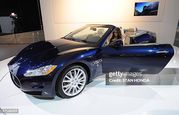 Model sits in a Maserati Gran Turismo convertible on display during the the second press preview day at the 2010 North American International Auto...