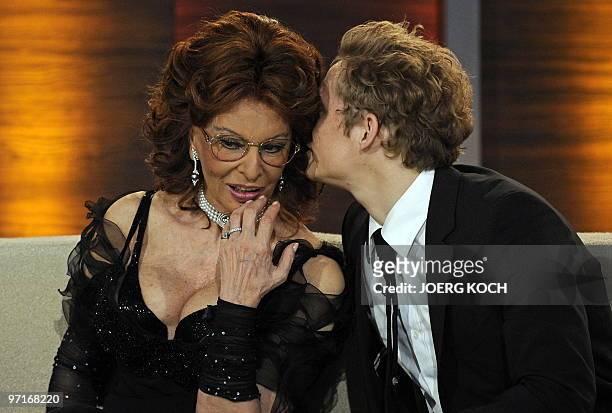German actor Matthias Schweighoefer whispers into Italian actress Sophia Loren's ear during the 187th edition of the TV show "Wetten, dass..?" on...
