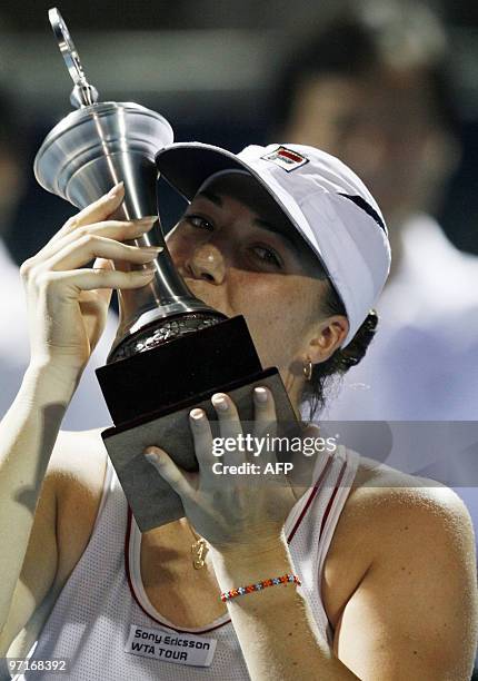 Russian tennis player Alisa Kleybanova kisses the trophy after defeating her compatriot opponent Elena Dementieva during the final match of the WTA...