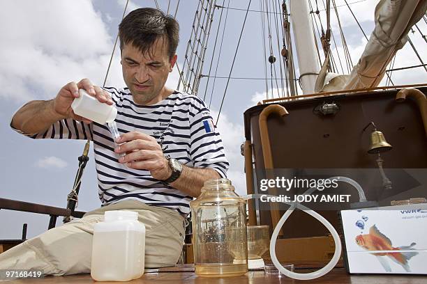French scientist at the University of Burgundy Jean-francois Buoncristiani takes samples of seawater on board of the French schooner La Boudeuse on...