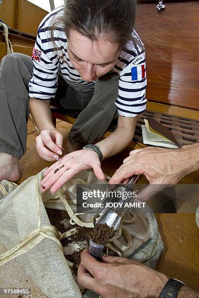 French scientist at the University of Burgundy Nathalie Franceschi takes samples of seabed on board of the French schooner La Boudeuse on the Maroni...