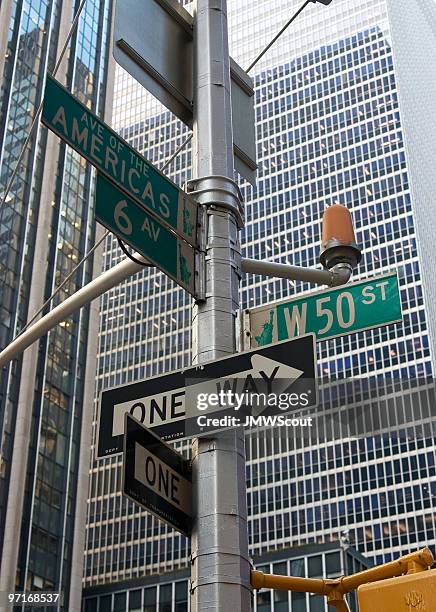 new york street sign avenue of the americas - one way stock pictures, royalty-free photos & images