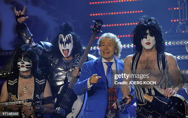 German showmaster Thomas Gottschalk stands next to US rock band "Kiss" after their performance during the 187th edition of the TV show "Wetten,...