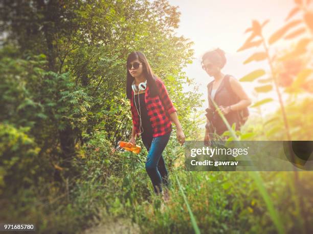 young women hiking in mountain woods. - gawrav stock pictures, royalty-free photos & images