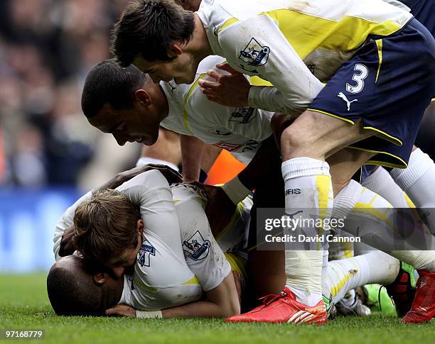 Roman Pavlyuchenko of Tottenham is congratulated by Tom Huddlestone, Jermain Defoe and Gareth Bale after scoring the first goal of the game during...
