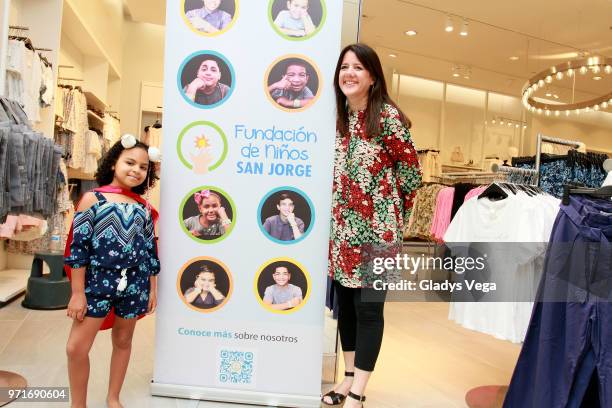 Stephanie Moore, head of San Jorge Children's Foundation poses with patient of San Jorge Children Hospital as part of H&M reopen at The Mall Of San...