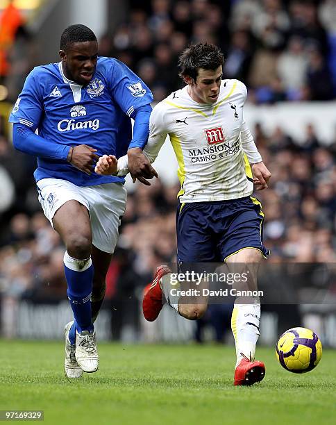 Gareth Bale of Tottenham and Victor Anichebe of Everton battle for the ball during the Barclays Premier League match between Tottenham Hotspur and...