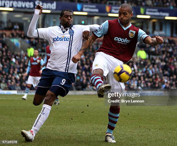 Frederic Piquionne of Portsmouth battles with Clarke Carlisle of Burnley during the Barclays Premier League match between Burnley and Portsmouth at...