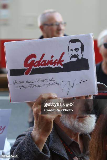 Man holding Lech Walesa sentence - ' I am strong in your strength, I am wise in your wisdom' in hand is seen in Gdansk, Poland on 11 June 2018 People...