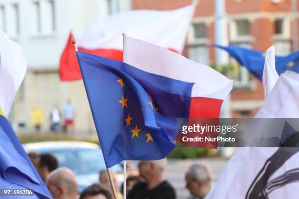 People holding flag of Poland and European Union are seen in Gdansk, Poland on 11 June 2018 People gather outside the courts around the country to...