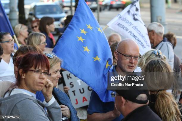 People holding flag of Poland and European Union are seen in Gdansk, Poland on 11 June 2018 People gather outside the courts around the country to...