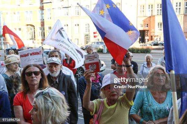 People holding flag of Poland and European Union and Polish constitution in hand are seen in Gdansk, Poland on 11 June 2018 People gather outside the...