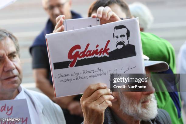 Man holding Lech Walesa sentence - ' I am strong in your strength, I am wise in your wisdom' in hand is seen in Gdansk, Poland on 11 June 2018 People...