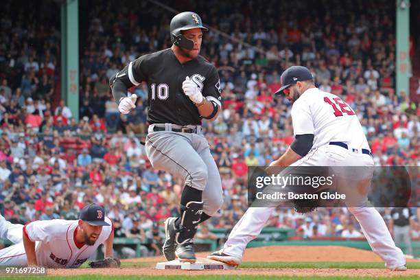 Chicago White Sox player Yoan Moncada beats the throw from Boston Red Sox pitcher Matt Barnes to teammate Mitch Moreland during the ninth inning. The...