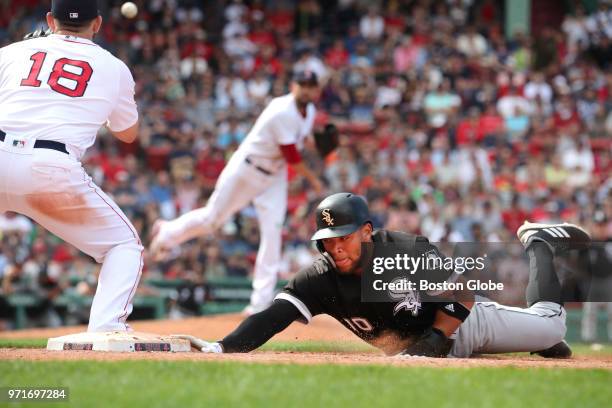 Chicago White Sox player Yoan Moncada beats the throw from Boston Red Sox pitcher, Matt Barnes to teammate Mitch Moreland during the ninth inning....