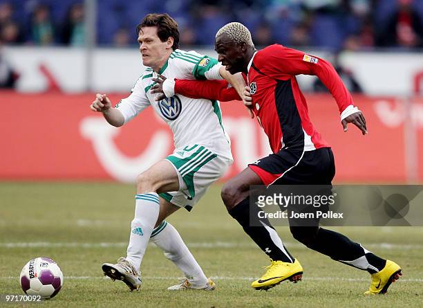 Arouna Kone of Hannover and Sascha Riether of Wolfsburg compete for the ball during the Bundesliga match between Hannover 96 and VfL Wolfsburgat...