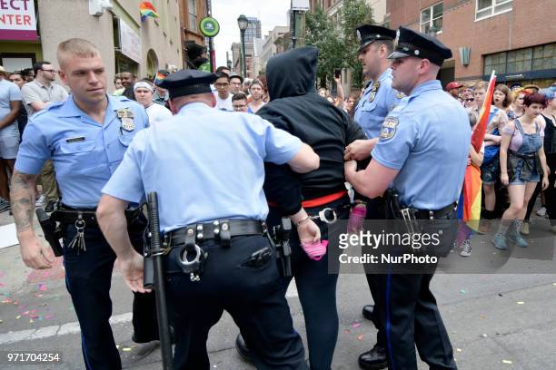 Police officers arrest a female, later identified as Ryan Segin after she attempted to lit a Blue Lives Matter flag in protest, ahead of the Pride...