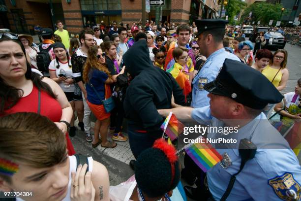 Police officers arrest a female, later identified as Ryan Segin after she attempted to lit a Blue Lives Matter flag in protest, ahead of the Pride...