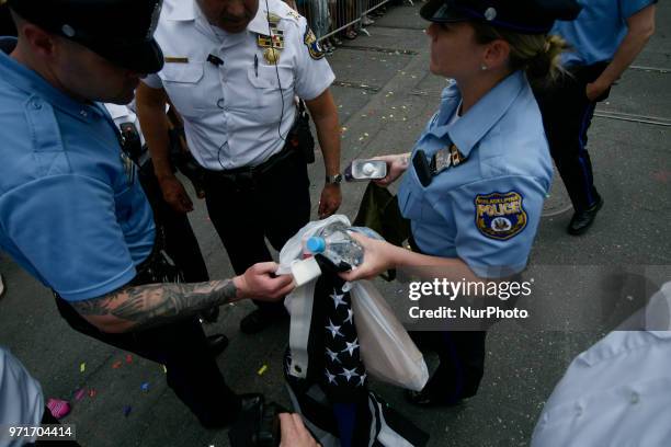 Police officers arrest a female, later identified as Ryan Segin after she attempted to lit a Blue Lives Matter flag in protest, ahead of the Pride...