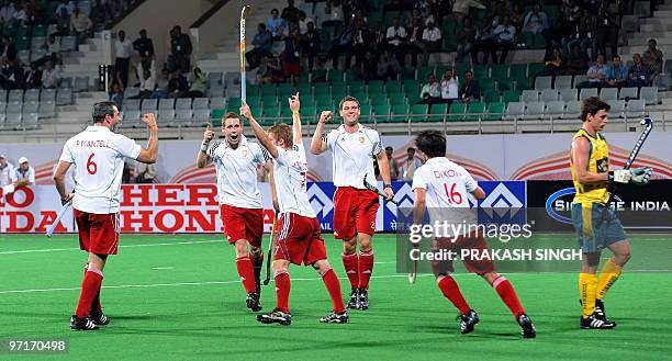 England hockey players celebrate a goal against Australia during their hockey World Cup 2010 match at the Major Dhyan Chand Stadium in New Delhi on...
