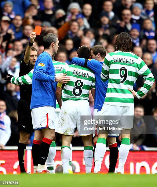 Steven Davis of Rangers consoles Scott Brown of Celtic as he is sent of by refereeDouglas McDonald during the Scottish Premier League match between...