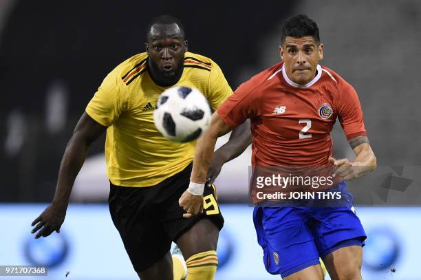 Belgium's forward Romelu Lukaku and Costa Rica's defender Johnny Acosta eye the ball during the international friendly football match between Belgium...