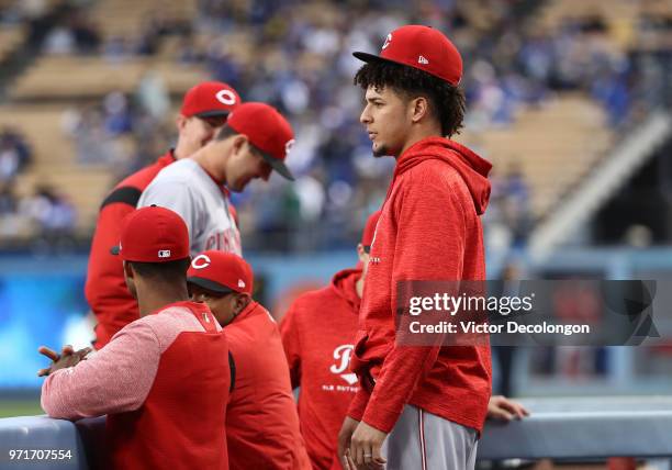 Pitcher Luis Castillo of the Cincinnati Reds looks on from the bench in the dugout prior to the MLB game against the Los Angeles Dodgers at Dodger...