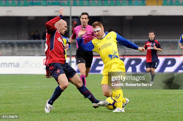 Michele Marcolini of Chievo competes with Andrea Parola of Cagliari during the Serie A match between Chievo and Cagliari at Stadio Marc'Antonio...