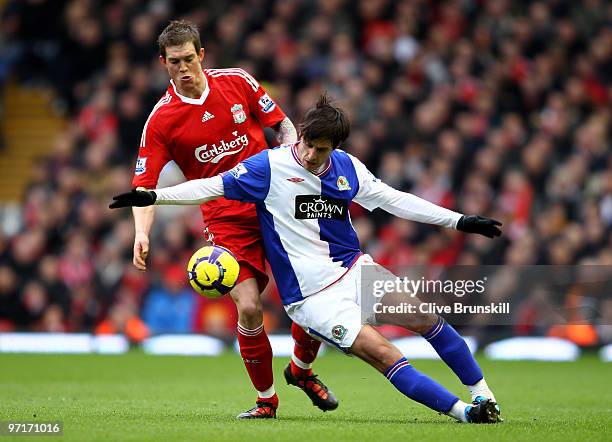 Daniel Agger of Liverpool challenges Nikola Kalinic of Blackburn Rovers during the Barclays Premier League match between Liverpool and Blackburn...