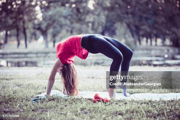 atleta femminile che si china all'indietro e si allunga nella natura - piegarsi allindietro foto e immagini stock