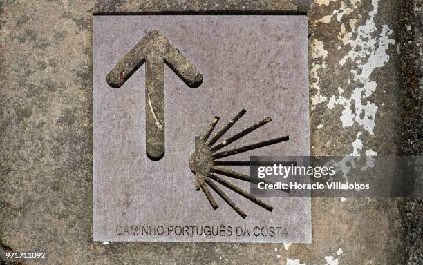 Pavement sign guides pilgrims through a narrow street, part of the Portuguese Coastal Way to Santiago, in downtown on May 28, 2018 in Vila do Conde,...