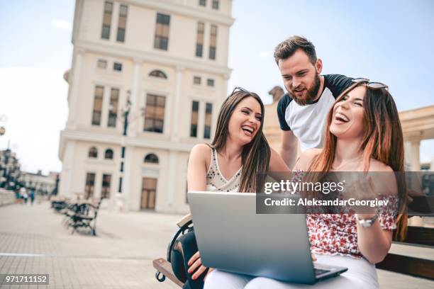 three friends searching the net and laughing at funny videos - human body part videos stock pictures, royalty-free photos & images