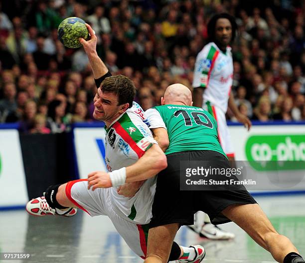 Bartosz Jurecki of Magdeburg is challenged by Robertas Pauzuolis of Hannover during the Toyota HBL match between TSV Hannover Burgdorf and SC...