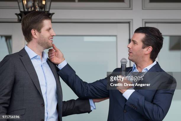 Eric Trump and Donald Trump Jr., who was making a joke about Eric not shaving today, speak during a ribbon cutting event for a new clubhouse at Trump...