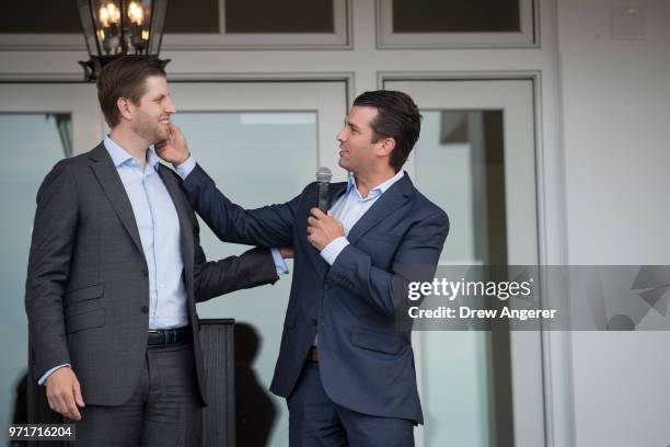 Eric Trump and Donald Trump Jr., who was making a joke about Eric not shaving today, speak during a ribbon cutting event for a new clubhouse at Trump...