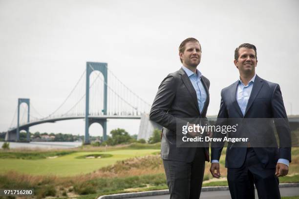 Eric Trump and Donald Trump Jr. Pose for photos during a ribbon cutting event for a new clubhouse at Trump Golf Links at Ferry Point, June 11, 2018...