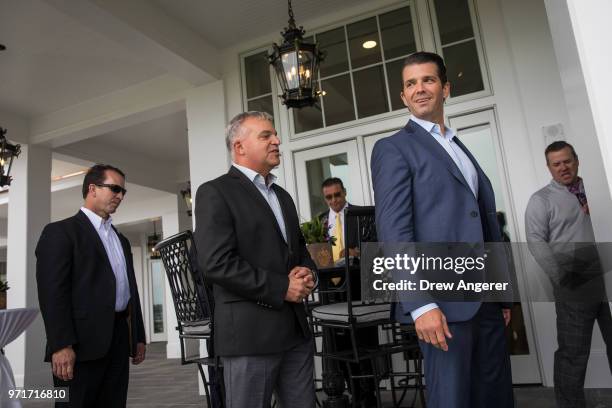 Donald Trump Jr. Mingles with guests following a ribbon cutting event for a new clubhouse at Trump Golf Links at Ferry Point, June 11, 2018 in The...