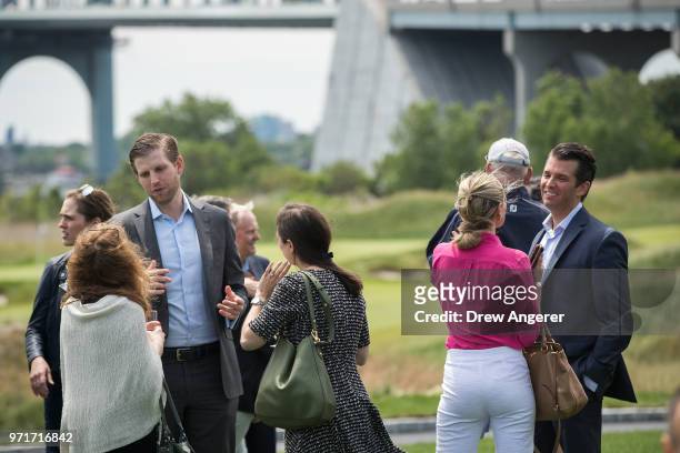 Eric Trump and Donald Trump Jr. Mingle with guests as they attend a ribbon cutting event for a new clubhouse at Trump Golf Links at Ferry Point, June...