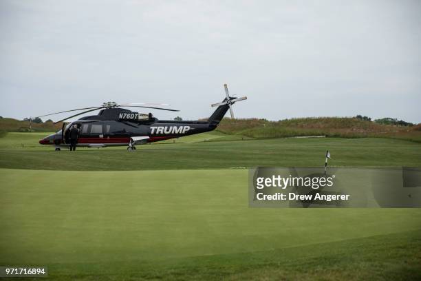 Branded helicopter sits near a putting green during a ribbon cutting event for a new clubhouse at Trump Golf Links at Ferry Point, June 11, 2018 in...