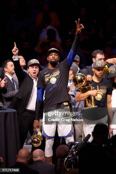 Finals: Golden State Warriors ownver Joseph S. Lacob, Kevin Durant holding MVP Tropy with Stephen Curry holding Larry O'Brien NBA Championship Trophy...