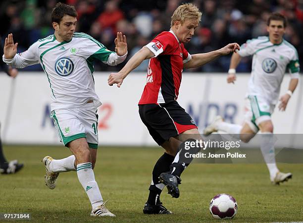 Mike Hanke of Hannover and Zvjezdan Misimovic of Wolfsburg compete for the ball during the Bundesliga match between Hannover 96 and VfL Wolfsburgat...
