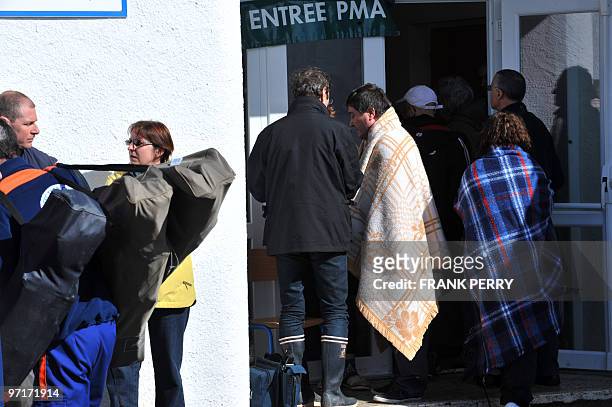 People wait in front of a local emergency medical center in La Faute-sur-Mer, western France, on February 28 following hurricane-force winds, surging...