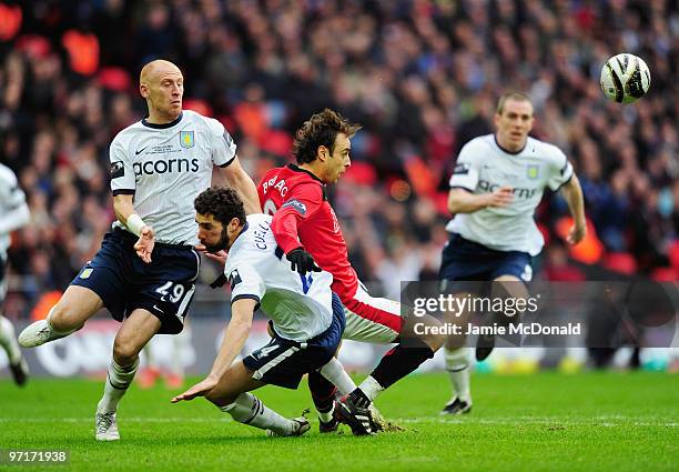 Dimitar Berbatov of Manchester battles with Carlos Cuellar and James Collins of Aston Villa of Aston Villa during the Carling Cup Final between Aston...