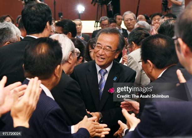 Hideyo Hanazumi, a candidate backed by the Liberal Democratic Party and Komeito, celebrates his election victory with his supporters on June 10, 2018...